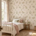 Framed botanical garden wallpaper with blush bows, sage greenery and pears in a child's bedroom