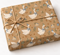 Birthday Goose Parade Kraft Gift Wrap on a wrapped kraft gift tied with natural twine on white
