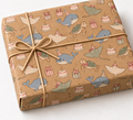 Ocean Bows Birthday Kraft Gift Wrap on a wrapped kraft gift tied with natural twine on white