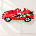 Red race-car foil balloon on a neutral backdrop