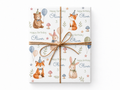 Personalized woodland birthday wrapping paper on a gift tied with natural twine